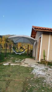 a house with a retractable canopy next to a house at Quinta São Miguel in Santo Antônio do Pinhal