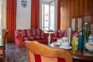 a living room with a table and a couch at Le Stanze Del Vicerè Boutique Hotel in Naples