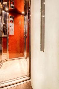 a glass door to a elevator in a room at Beautiful and cozy studio next to Athens center in Athens