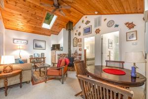 a living room with a wooden ceiling at Tree Top View Cabin in Felton