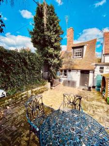 a blue table and chairs in front of a house at The Nutshell in West Mersea