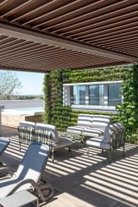 a group of lounge chairs on a patio at Sea Breeze in Caorle