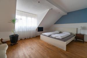 a bedroom with a bed and a large window at Hotel Albani in Winterthur