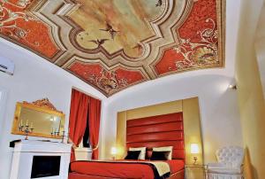 a bedroom with a bed and a painting on the ceiling at AMM Luxury Rooms in Rome