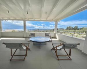 d'une table et de chaises sur un balcon avec vue sur l'océan. dans l'établissement Villa Mila Kastela, à Kaštel Novi