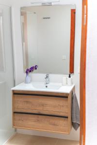 a bathroom with a sink and a mirror at Casa Carmen in Haría