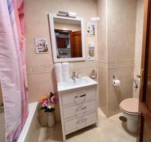 a bathroom with a sink and a toilet and a mirror at Estudios Costavigía Mazagón by Ramona in Mazagón +37 photos
