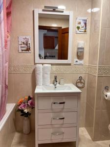 a bathroom with a sink and a mirror at Estudios Costavigía Mazagón by Ramona in Mazagón