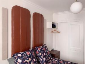 a room with a couch with two pillows at Chambre d’hôtes - Marais in Paris