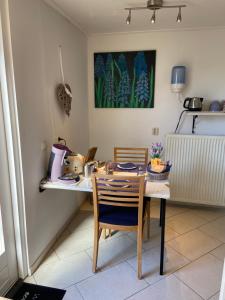a dining room table with two chairs and a table with at Guest House Open Doors in Almere