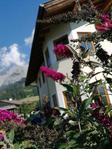 una farfalla seduta su un fiore accanto a un edificio di Prandhof a Pfarrwerfen