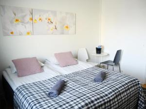 a bedroom with a bed with two pillows on it at Scandinavian Sweet home 30 Työmiehenkatu 2 in Helsinki