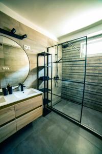 a bathroom with a shower and a sink and a mirror at Kégli_Fonyód in Fonyód