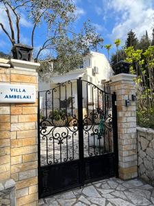 a gate to a villa with a sign in front of it at Villa Ampelaki "30 meters to beach" in Paleokastritsa