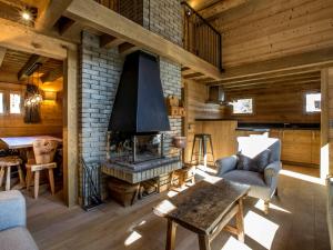 a living room with a fireplace in a log cabin at Chalet Val-d'Isère, 5 pièces, 8 personnes - FR-1-694-6 in Val-d'Isère