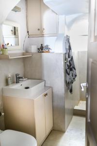 a small bathroom with a sink and a toilet at Castro House in Pera Gyalos