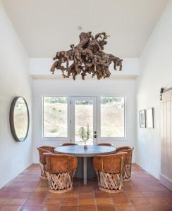 a dining room with a table and chairs and a chandelier at Contigo Ranch Fredericksburg in Fredericksburg