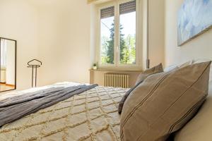 a bedroom with a bed and a window at Virginia Apartments in Parma