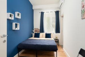 a bedroom with a blue accent wall and a bed at Affittacamere Z&I in Florence