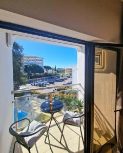 a balcony with a view of a parking lot at ZARCO - Apartment in Vilamoura with 2 Pools near the Beach & the Marina in Quarteira