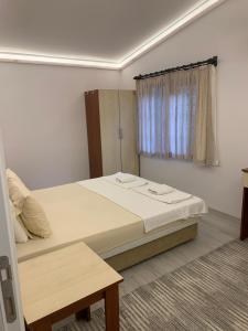 a bedroom with a large bed and a window at Adabella Pension in Cıralı