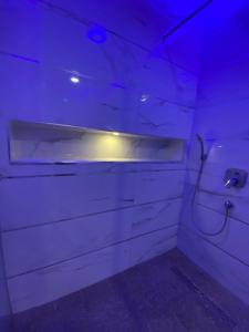 a dark room with a toilet with a light on it at 2-Bedroom Apartment in Ikoyi in Lagos