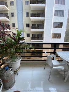 a balcony with a table and chairs and buildings at 2-Bedroom Apartment in Ikoyi in Lagos