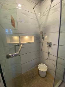 a small bathroom with a toilet and a shower at 2-Bedroom Apartment in Ikoyi in Lagos