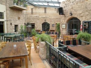 a patio with tables and chairs in a restaurant at Laura’s Modern Villa in Madaba