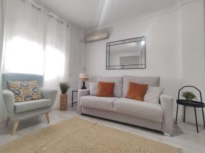 Biały salon z kanapą i krzesłem w obiekcie Covadonga Suite Home w Sewilli +20 zdjęć
