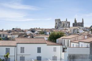een stad met witte gebouwen en een kasteel op de achtergrond bij Appartement duplex "Atlantis" proche du port in Saint-Martin-de-Ré