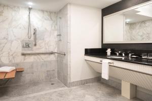 a bathroom with a shower and a sink at The Ritz-Carlton, South Beach in Miami Beach