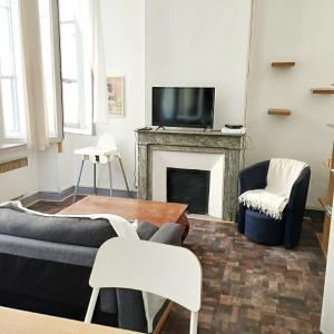 a living room with a couch and a fireplace at Massilia in Marseille