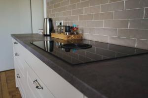 a kitchen counter with a black counter top at Villa Rosa - Sky in Detmold