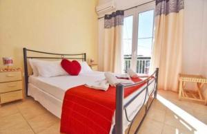 a bedroom with a bed and a large window at River Beach House in Mesongi