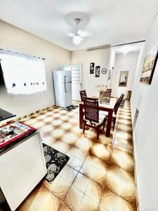 a living room with a table and a refrigerator at Divino Espírito Santo in Aparecida
