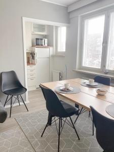 a dining room with a wooden table and chairs at Scandinavian Home 17 city Center Työmiehenkatu 2B in Helsinki