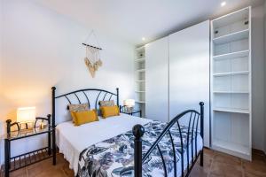 a bedroom with a bed and a closet at Salema Beach House in Salema