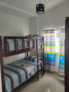 a bedroom with two bunk beds in a room at LA POSADA DE NEIZAN in Bocapán