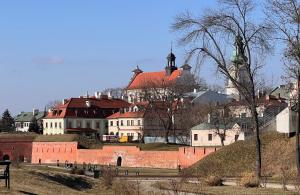 a group of buildings on a hill with a castle at Hotel77 in Zamość