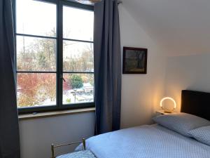 a bedroom with a bed and a large window at Haus Charlotte in Papstdorf