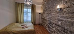a bedroom with a brick wall and a bed at Old Town Tallinn Luxury Residence in Tallinn