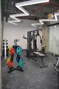 a gym with several exercise equipment in a room at Ulivin Coliving in Manizales