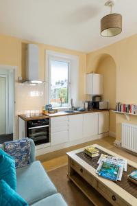 a kitchen with a couch and a table in a room at Ilkley Studio in Ilkley