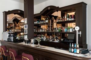 a bar with a lot of bottles of alcohol at Soho Boutique Palacio de Pombo in Santander