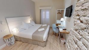 Posteľ alebo postele v izbe v ubytovaní Madeinterranea Suites