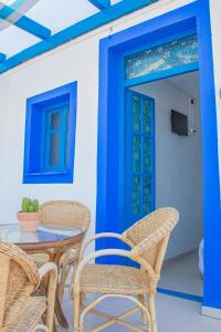 La Esperanza Beach- Zona Pubs y Restaurantes في موجاكار: فناء مع طاولة وكراسي وباب أزرق