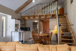 a living room with a loft bed and a kitchen at Les collines 