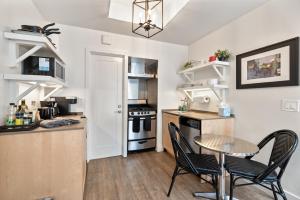 a kitchen with a table and chairs and a kitchen with a stove at Seashore Studio in San Diego