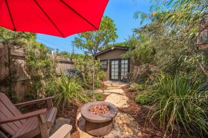 a patio with a red umbrella and a chair at Seashore Studio in San Diego +7 photos